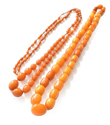 Lot 181 - An amber bead necklace, length 68cm; and an...