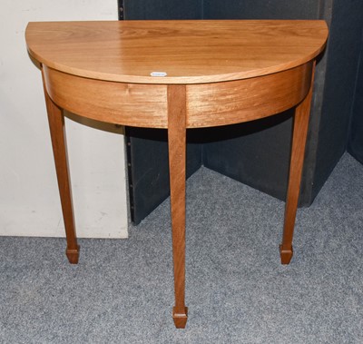 Lot 1189 - A reproduction hardwood demi lune side table...