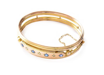 Lot 166 - A synthetic sapphire and diamond hinged bangle,...