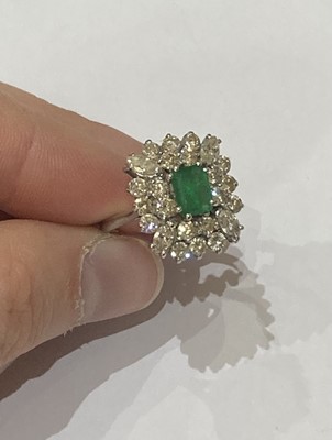 Lot 2295 - An 18 Carat White Gold Emerald and Diamond Cluster Ring