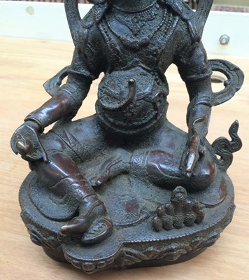 Lot 217 - A Sino-Tibetan bronze figure of Vaisravana,...
