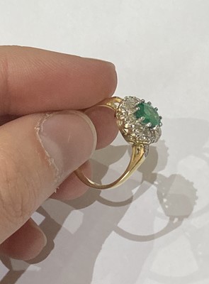 Lot 2296 - An Emerald and Diamond Cluster Ring