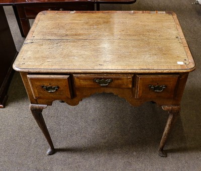 Lot 1246 - A George II crossbanded oak lowboy, on...