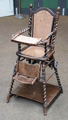 Lot 1291 - A 1920s oak metamorphic high chair, with cane...