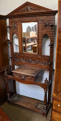 Lot 1210 - A late Victorian carved oak hallstand with...