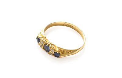 Lot 197 - An 18 carat gold sapphire three stone ring,...