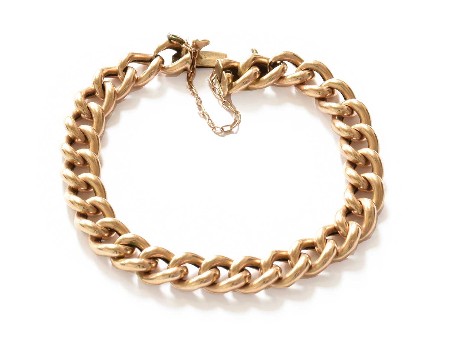 Lot 205 - A curb link bracelet, tongue stamped '15CT',...