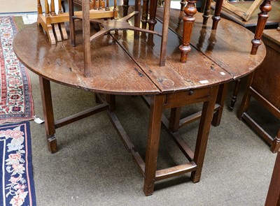 Lot 1217 - An 18th century oak gateleg dining table,...