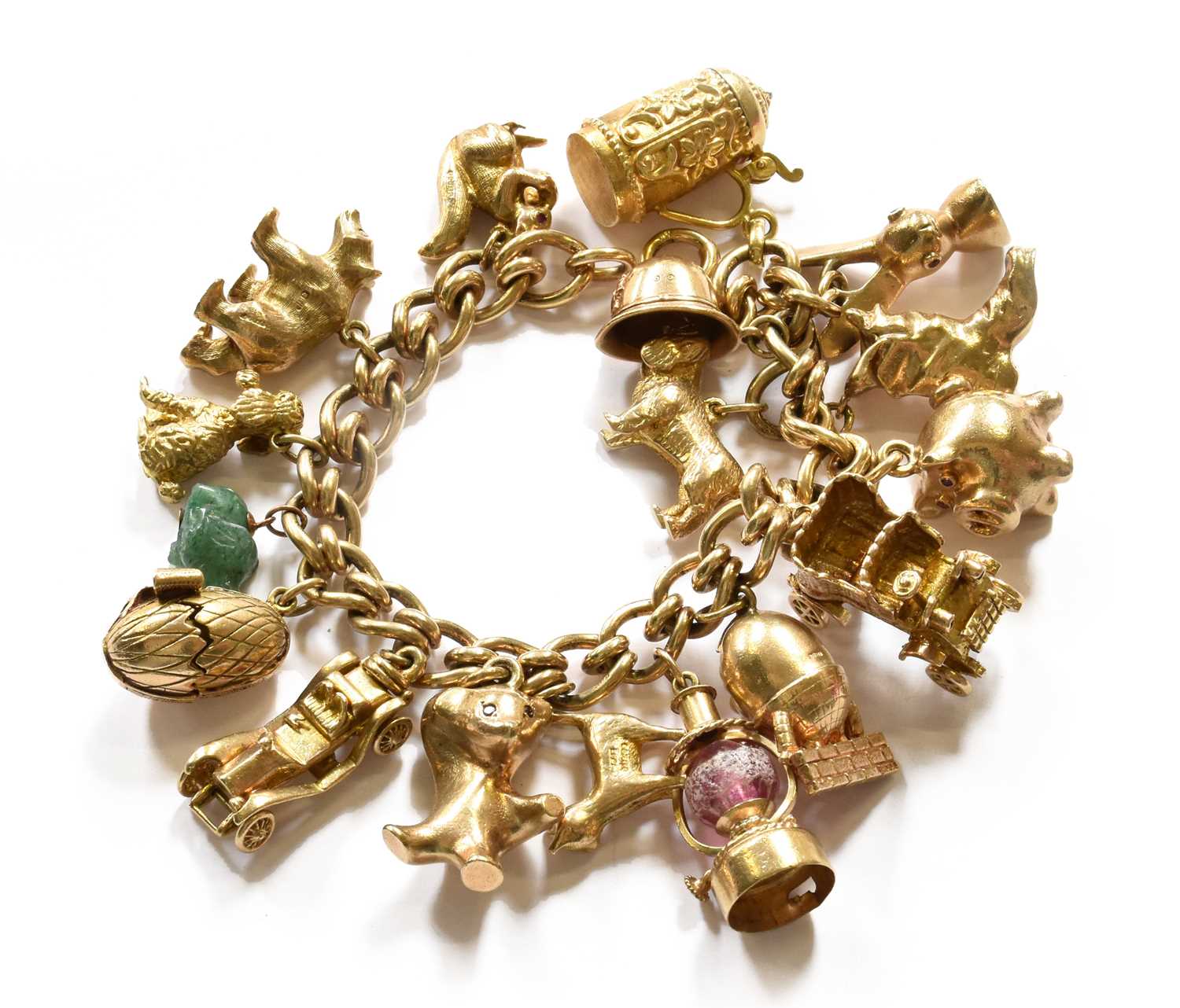 Lot 203 - A charm bracelet, stamped '9' and '.375', hung...