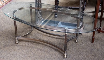 Lot 1125 - A glass top oval table