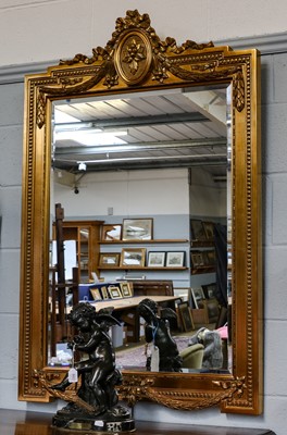 Lot 1281 - A reproduction gilt mirror, ornamented with...