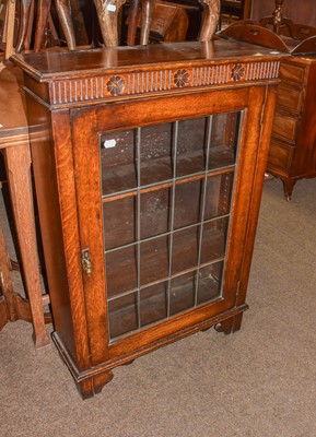 Lot 1311 - A small 20th century oak bookcase with leaded...