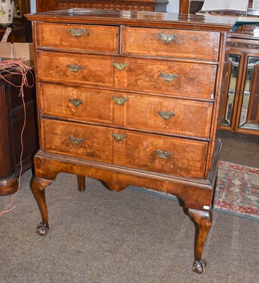 Lot 1250 - A Queen Ann walnut chest on stand, feather...