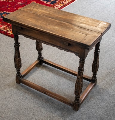 Lot 1168 - A 20th Century carved oak writing table, the...