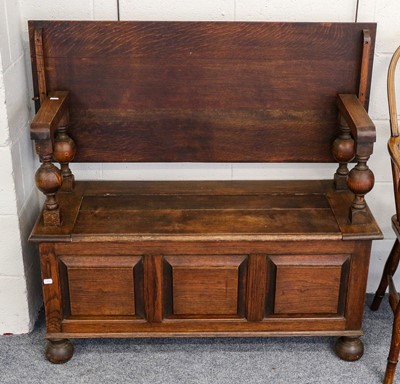 Lot 1150 - An oak monks bench with panelled front and...