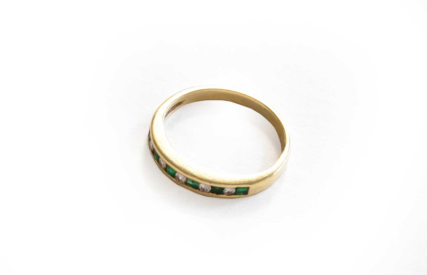 Lot 13 - A emerald and diamond half hoop ring, stamped '...