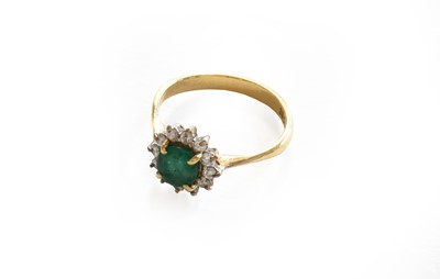 Lot 185 - An emerald and diamond cluster ring, stamped...