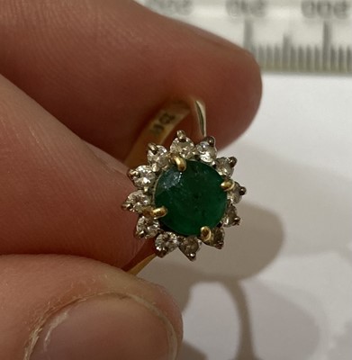 Lot 14 - An emerald and diamond cluster ring, stamped...