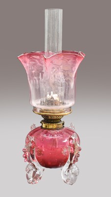 Lot 69 - A Victorian cranberry glass oil lamp, the...