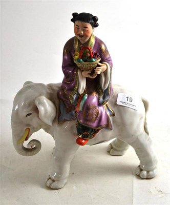 Lot 19 - A Chinese elephant and girl figurine
