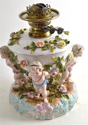 Lot 25 - A flower-encrusted porcelain oil lamp