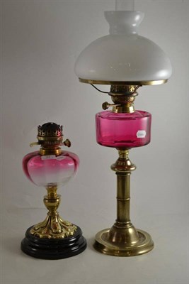 Lot 32 - Two cranberry oil lamps