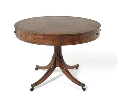 Lot 1181 - An Elegant George III Mahogany Library Drum Table, circa 1800, the worn red and gilt leather...