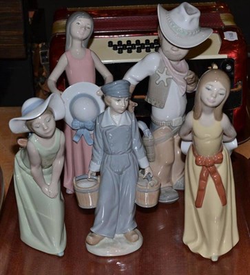Lot 45 - Three Lladro figurines of women with hats, a cowboy and a milkmaid (5)