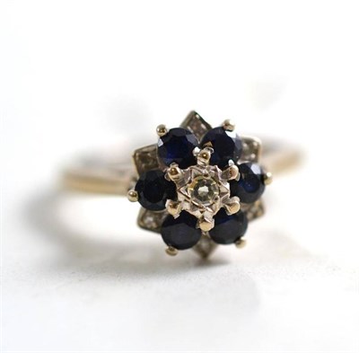 Lot 52 - A diamond and sapphire cluster ring stamped '18ct'