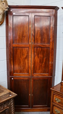 Lot 1265 - A Georgian mahogany double corner cupboard...