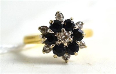 Lot 68 - An 18ct gold diamond and sapphire cluster ring