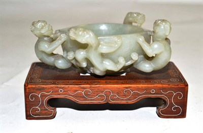 Lot 70 - A Chinese dragon bowl carved in jade with wooden stand