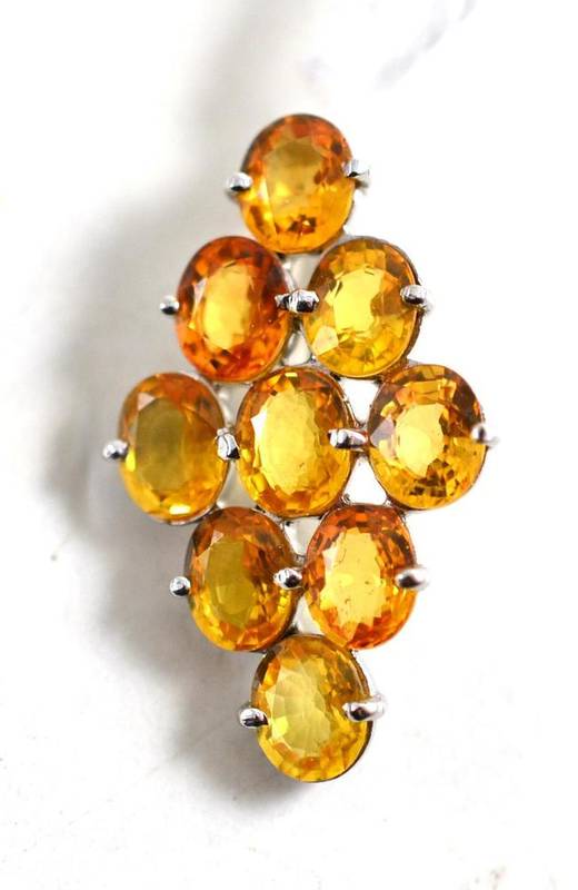 Lot 74 - An 18ct white gold yellow sapphire pendant