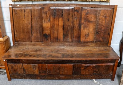 Lot 1203 - A rustic panelled oak settle, 182cm by 53cm by...