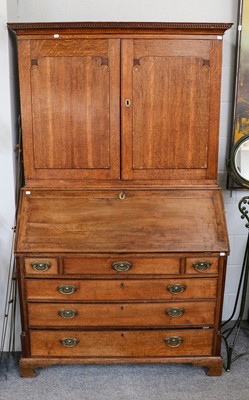 Lot 1122 - A George III oak bureau bookcase, the upper...