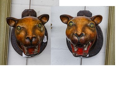 Lot 1147 - A pair of painted carved wooden leopard heads