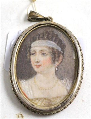 Lot 86 - Portrait miniature of a lady with Grecian hairstyle, in .800 white metal frame