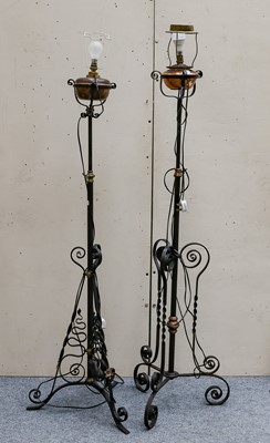 Lot 1233 - A pair of wrought iron oil lamp stands...