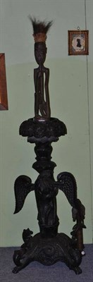 Lot 97 - An Anglo Indian ebonised plant stand and two tribal carvings (3)