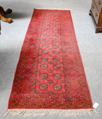 Lot 1116 - Afghan Runner, the crimson field with two...