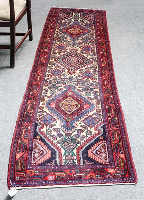 Lot 1117 - A narrow North West Persian runner, the cream...