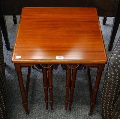 Lot 1182 - A nest of three teak occasional tables raised...