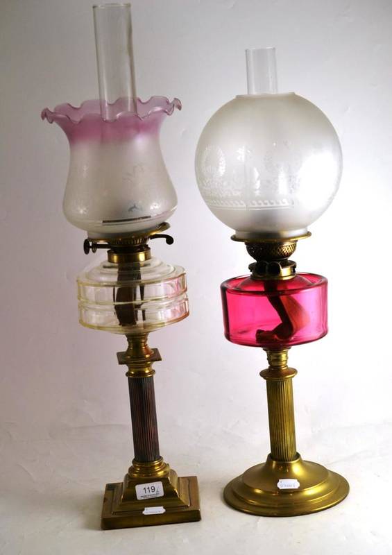 Lot 119 Two brass oil lamps with glass chimneys and