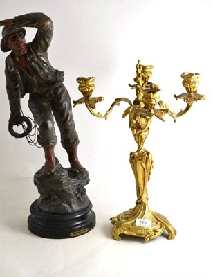 Lot 122 - A spelter figure and a four branch candelabrum