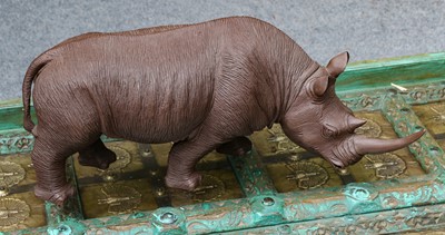 Lot 386 - A carved wooden sculpture of a rhinoceros,...