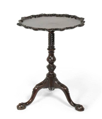 Lot 1192 - A George II Style Mahogany Tripod Table, the associated pie crust top above a part-wrythen and...