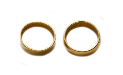 Lot 330 - Two 22 carat gold band rings, finger sizes K...