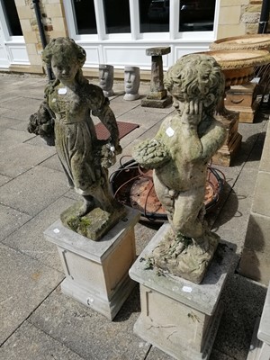 Lot 1117 - A pair of weathered composition garden statues...