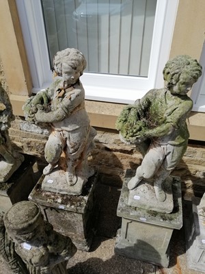 Lot 1120 - A pair of weathered composition garden statues...