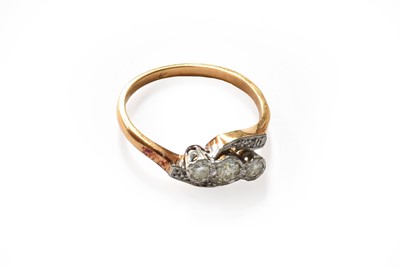 Lot 269 - A diamond three stone twist ring, stamped...